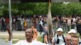 Snoop Dogg carries the Olympic torch before opening ceremony in Paris