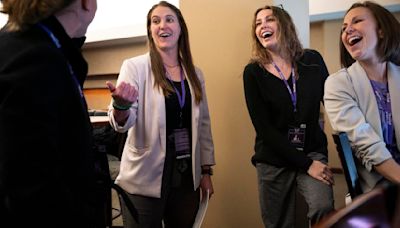 Natalie Darwitz, general manager of the PWHL's Minnesota team, laughs with some of the team's directors, from...and partner activation, Claire Bjerke, director of game operations and assistant to team services, and Emily Wood, director of team services, as they watch the game against Montreal from a suite in the Xcel Energy...