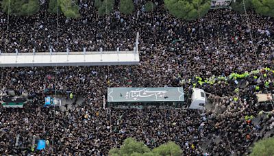 Iran's Raisi buried in Mashhad as mourners pack Iranian holy city