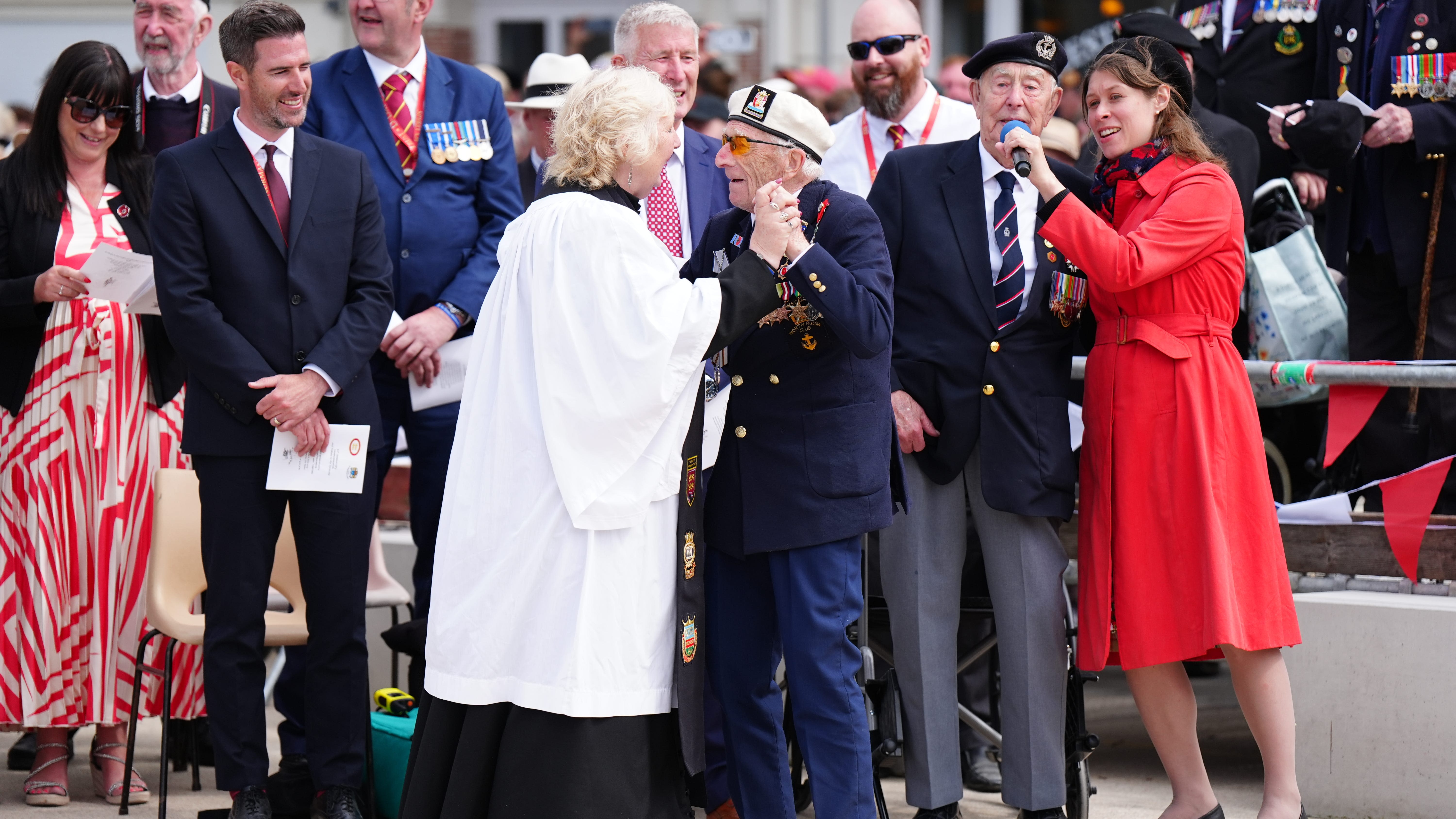 Veterans sing and dance at close of town commemoration service in Normandy