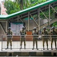 Bangladeshi soldiers stand guard at a metro station in Dhaka after last week's deadly anti-job quota protests