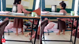 UP teacher in Aligarh naps in classroom as primary school kids found fanning her. Video goes viral - The Economic Times