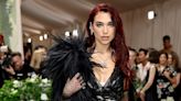 Dua Lipa Carries a Feathered Cape Over a See-Through Lace Set at the 2024 Met Gala