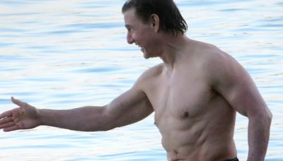 Tom Cruise, 61, shows off his shirtless physique for a dip in Majorca