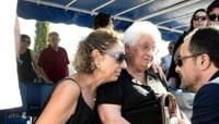 Cypriot President Nikos Christodoulides (R) talks with the widow of a soldier killed in the 1974 Turkish invasion of Cyprus, at Makedonitissa military cemetery in Nicosia,