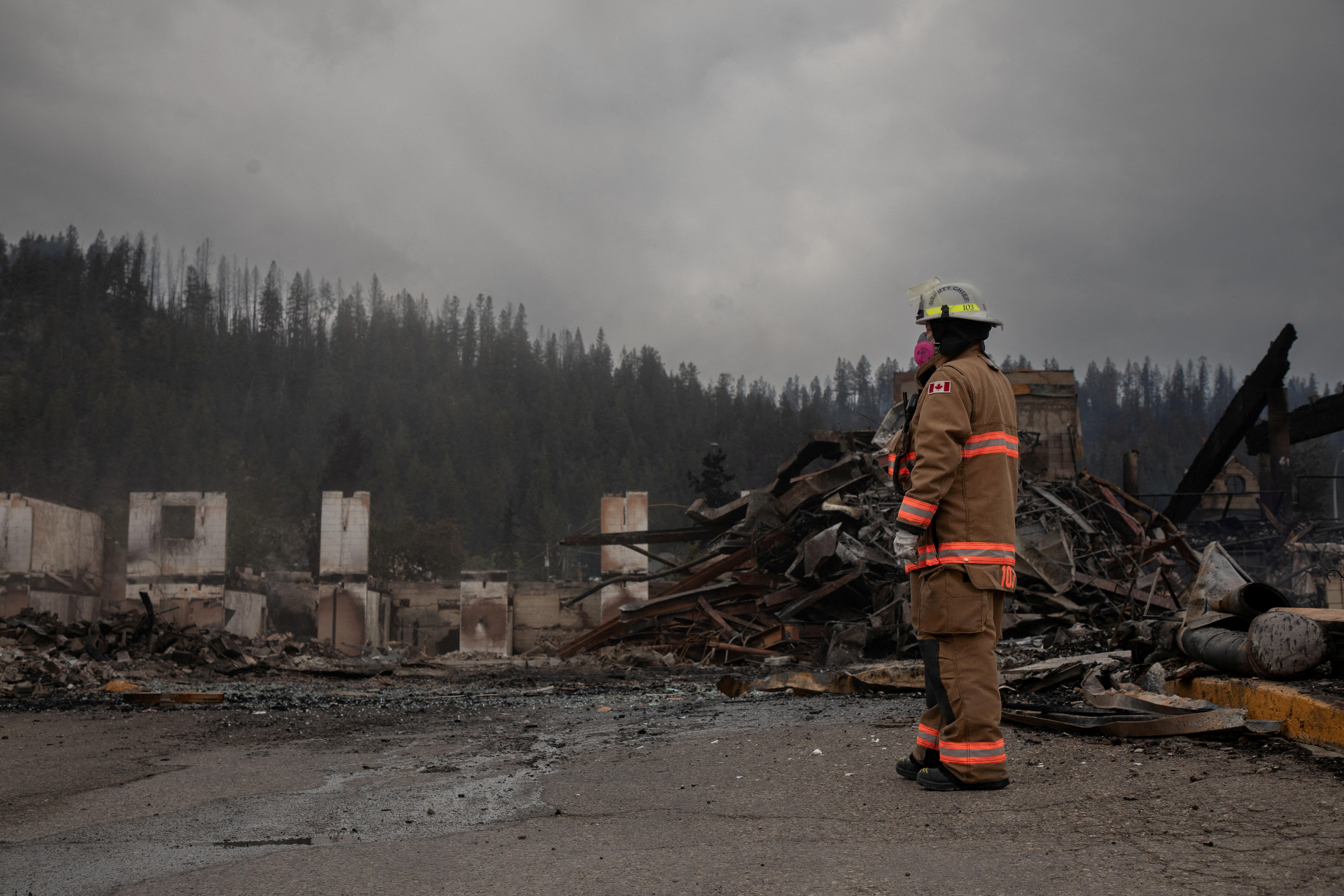 Jasper, Canada fire chief watches house burn as he rushes to save town