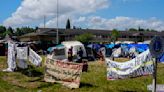 Hundreds of asylum-seekers are camped out near Seattle. There's a vacant motel next door