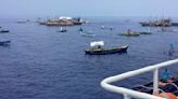 About 100 Filipino activists and fishermen sail on wooden boats to disputed shoal guarded by China