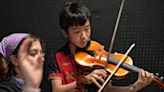 Sharing a few notes: High schoolers coaching younger string players one on one