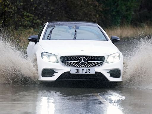 How should I drive if I get caught in a thunderstorm?