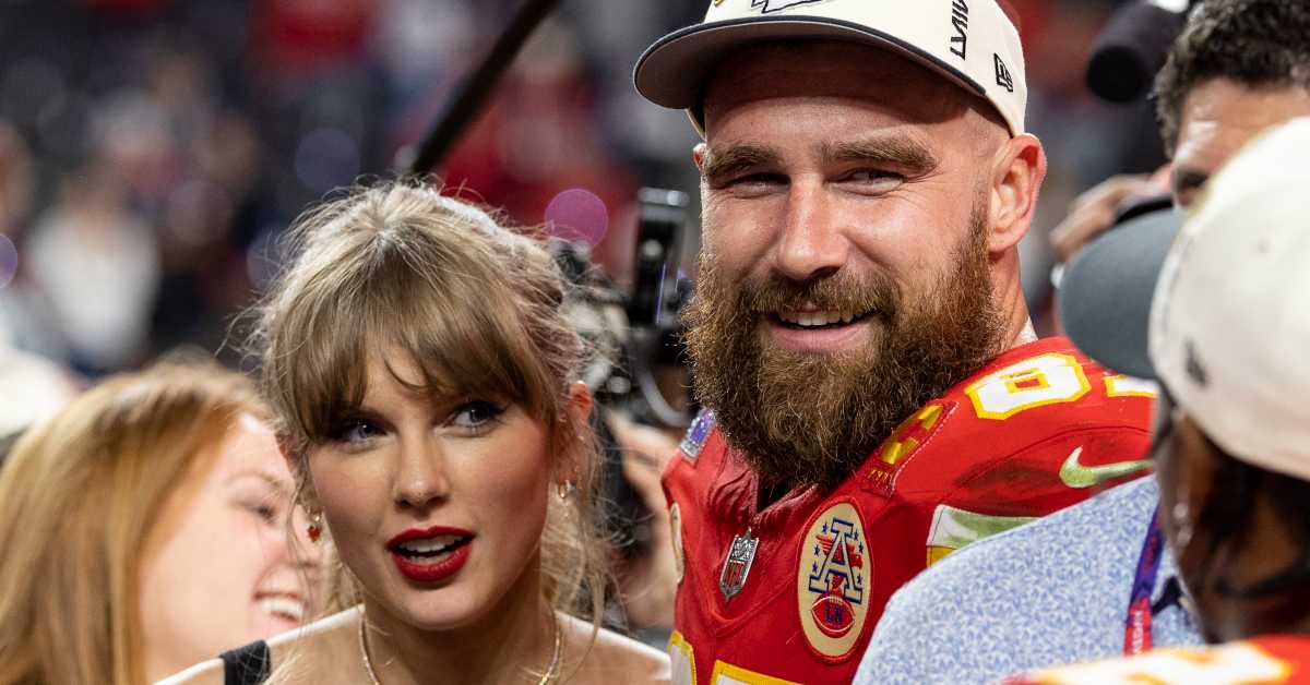 Fans Are ‘In Tears’ As Travis Kelce Carries Taylor Swift In ‘Unhinged’ Surprise Eras Tour Moment