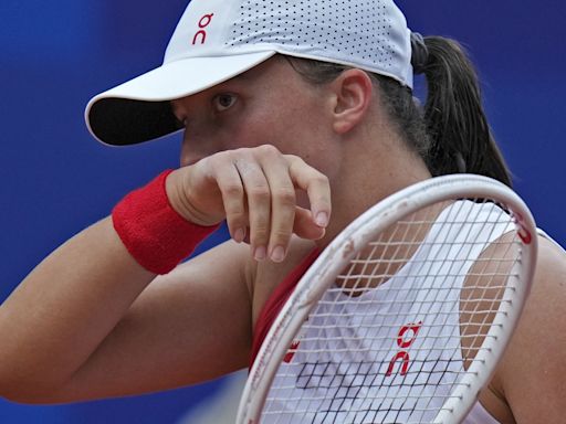 Olympics tennis: No. 1 Iga Swiatek gets hit by a ball but wins when Danielle Collins of the US stops