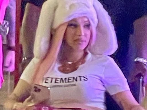 Pregnant Cardi B is pushed in a wheelchair in quirky bunny hat