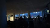 Passengers sit in the dark at San Francisco airport after power outage