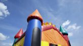 Child killed, another injured after bounce house swept up by wind