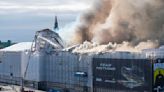 Fire rages through the 17th-century Old Stock Exchange in Copenhagen, toppling the iconic spire