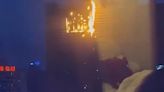 Towering inferno as massive fire on hotel sends flames dripping onto street