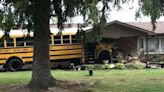 School bus with over 30 students on-board crashes into College Corner home; Driver injured