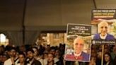 Israelis carry posters with images of hostages held in Gaza at a rally in Tel Aviv on Holocaust Remembrance Day