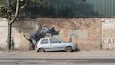 Banksy unveils rhino art that looks as though animal is climbing on a car