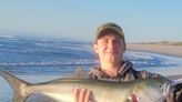 Fishermen fighting bluefish at Manasquan Inlet, Island Beach