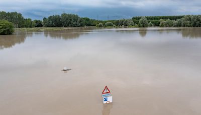 Cars are washed down the road as huge floods hit Italy and Switzerland