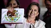 Mexican presidential candidate Xóchitl Gálvez shows a national flag while speaking during a press conference at the National Electoral Institute headquarters in Mexico City on April 7, 2024.