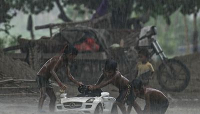 Ten dead as freak torrential rains flood Indian capital region, closing schools and offices