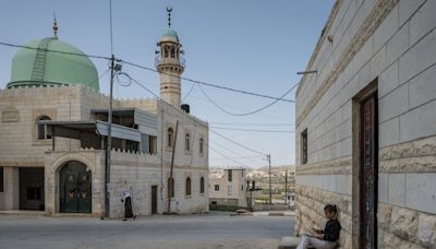 In the West Bank, Guns and a Locked Gate Signal a Town’s New Residents