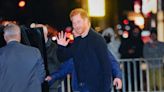 Harry waves to fans as he arrives at Stephen Colbert’s The Late Show with armed security