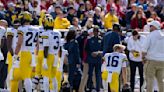 Michigan assistant coach Hart carted off field on backboard