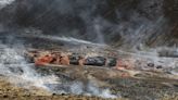 An Iceland volcano spews red streams of lava toward an evacuated town