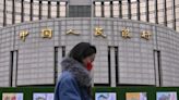 China cuts 1-year benchmark rate, moving to boost economy as world markets languish