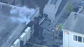 Man seen fighting SoHo building fire with garden hose from neighboring roof