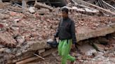 Indonesia quake survivor grieves 11 relatives as he rebuilds