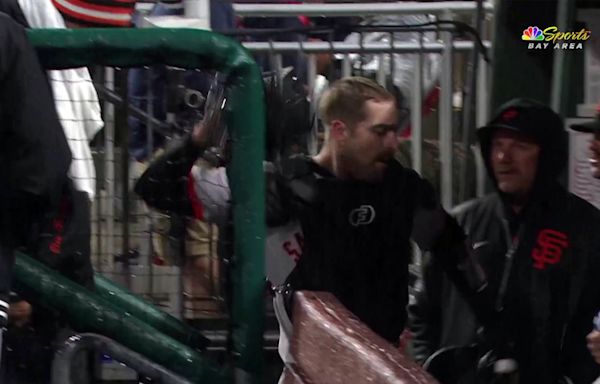 Giants catcher Murphy angrily slams gear after injuring knee in downpour