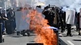 Protesters throw projectiles, police fire tear gas grenades in clash after French port blockade