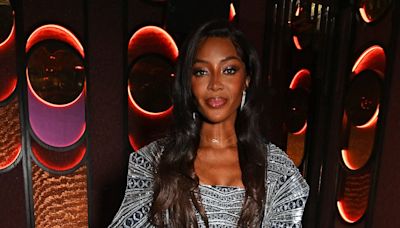 Naomi Campbell puts on a leggy display in silver mini dress