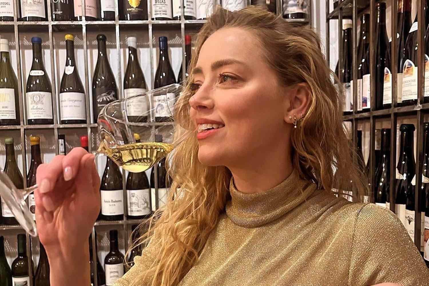 Amber Heard Smiles and Sips Champagne in Rare Photo to Celebrate Her 38th Birthday