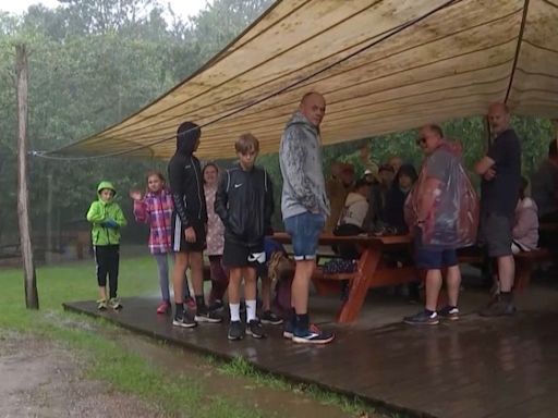 ‘We’ll just put on the yes hat’: Tourists try to stay positive in the face of Denmark’s wet weather