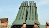 North Korean leader Kim Jong Un inspects the 240mm multiple rocket launcher system at an undisclosed location