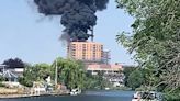 Huge fire breaks out on roof of Surrey block of flats