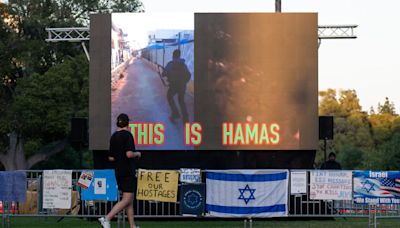 Screens playing loop of Hamas Oct. 7 attacks erected facing campus protests