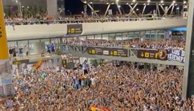 WATCH: 5,000 Malaga fans pack out airport to welcome promotion heroes home at 05:30am