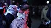 NYPD officers in riot gear break into a building at Columbia University, where pro-Palestinian students are barricaded inside a building and have set up an encampment, in New York City on April 30, 2024