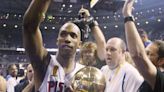 The Detroit Pistons' Chauncey Billups celebrates with the MVP trophy while leaving the court after eliminating the Los Angeles Lakers in Game 5 of the NBA...