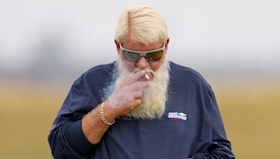 John Daly smokes a cigarette in neon tartan shorts at Royal Troon