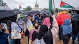 Hundreds of pro-Palestinian protesters rally in the rain in DC to mark a painful present and past