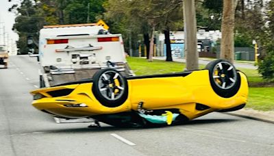 Shocking moment a $900k Ferrari is flipped upside down on a busy road