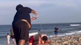 Beach erupts into chaos after teenager hurls water at couple